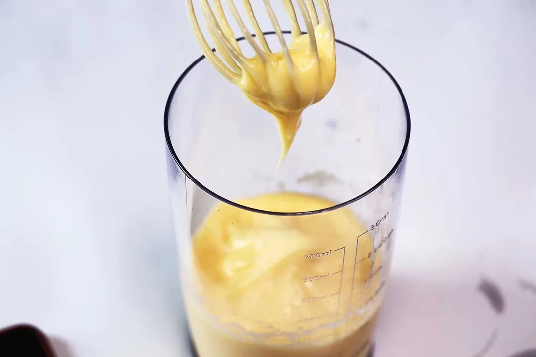 A little bit of mayonnaise was sticking on the blender whisk attachment when it was removed from the full batch emulsified in a 24-oz plastic beaker.