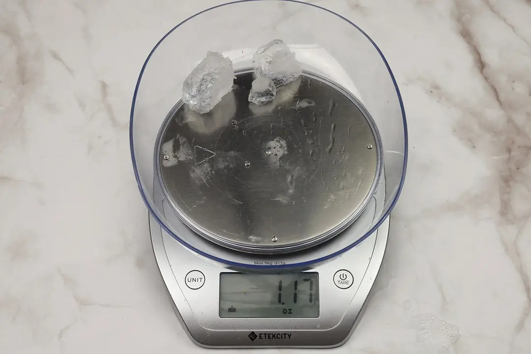 The amount of unblended ice cubes (1.17 oz) of the Ninja Fit personal blender displayed on a scale’s screen.