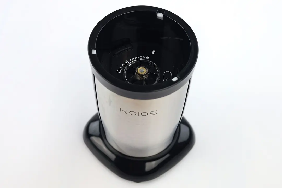 The motor base of the KOIOS Bullet personal blender standing on a white table. 