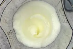 Inside the plastic beaker containing a batch of beaten egg-white prepared by the Mueller Ultra-Stick immersion blender.