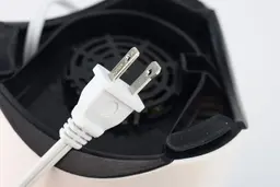 A close-up of the power cord sporing a 2-plug in the underside of the Oster’s motor base.