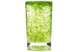 A glass of water combined with fibrous greens pulp produced by the Ninja BL480D Nutri 1000-Watt. 