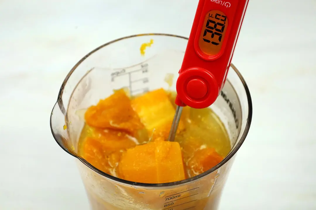 Before blending, use a red thermometer to ensure the soup in a 24-oz beaker is at the right temperature (138°F). 