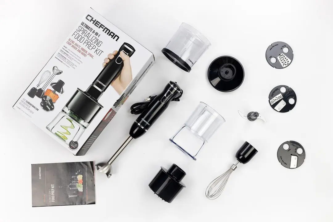 The Chefman Immersion Blender and its accessories, including a whisk attachment, three spiralizing blades, a spiralizer, a food processor, and a user manual.