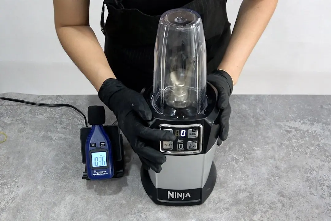 Someone is measuring the noise level of the Ninja BL480D Nutri personal blender with the noise meter (103.6 dB).