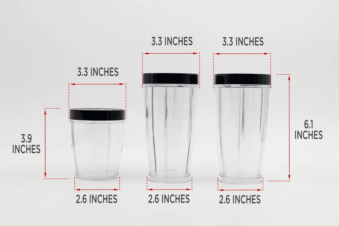 Three blending cups of the BELLA Rocket blender on a table, with dimension measurements written to the side. The first cup is measured 3.3x3.9x2.6 inches, second cup is 3.3x6.1x2.6 inches, third cup is 3.3x6.1x2.6 inches.