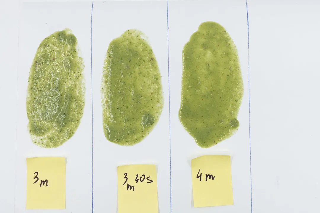 Three spoons of Cuisinart’s green smoothie were spread evenly on a white paper with blending times of each indicated below (3 minutes, 3 minutes and 30 seconds, and four minutes).