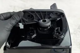Someone is holding the centering pad of the Vitamix 5200’s motor base