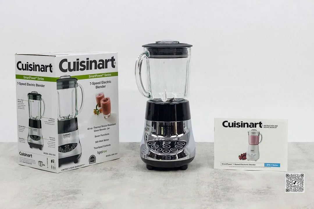 The Cuisinart SmartPower Blender is on a table with the packaging box and user manual by its sides.