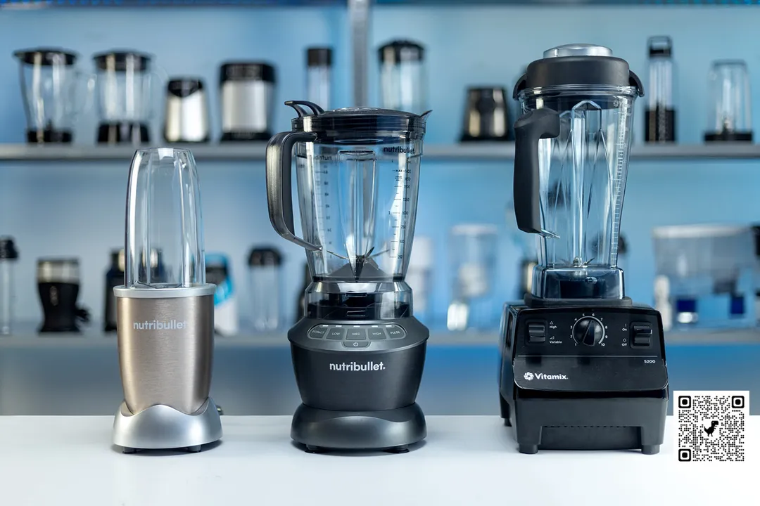 Our best blenders for smoothies, including the NutriBullet Pro, NutriBullet, and Vitamix 5200, are standing on a table. Different machines are in the background.
