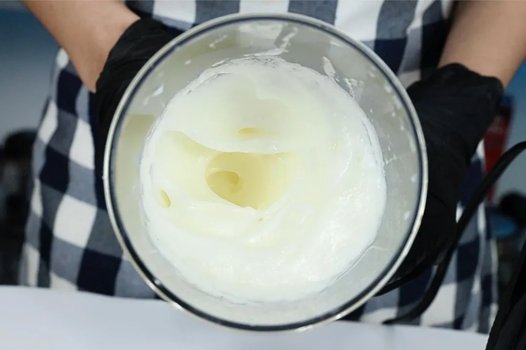 Stiff peak egg whites in the 24-oz plastic beaker.
