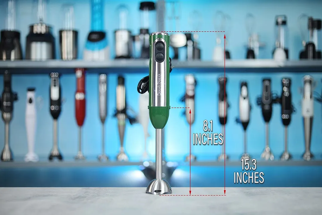 The Peach Street Hand Blender stands on top of its blending shaft on a table, with the length of the blending shaft being noted to the side as 8.1 inches, and the total length of the unit as 15.3 inches.