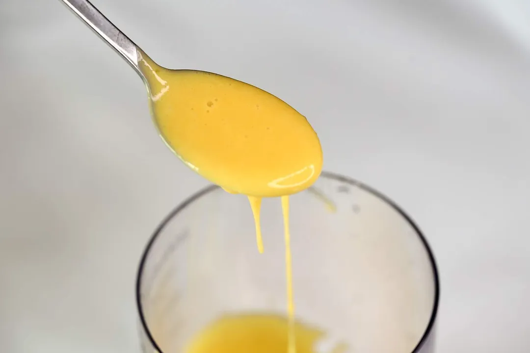 spoon of yellow running liquid