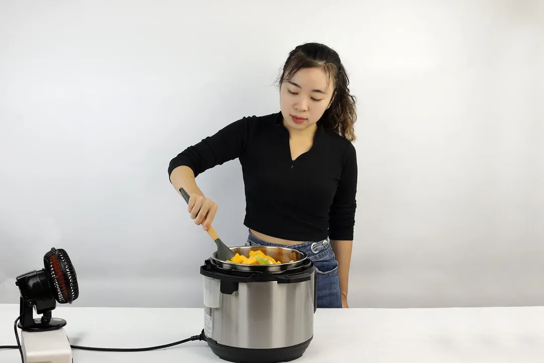 woman cooking with a pressure cooker
