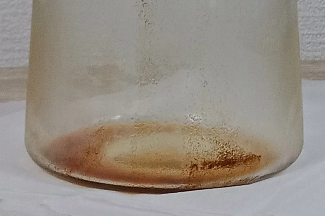 Sediment at the bottom of the Oxo compact cold brew coffee carafe after all the coffee has been carefully decanted out.