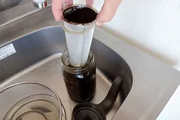 A short video showing how to decant the filter of a cold brew coffee maker after 18 hours of brewing.