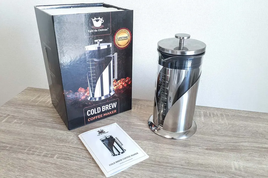 The fully-assembled Chateau du Cafe cold brew coffee maker standing to the right of its box.