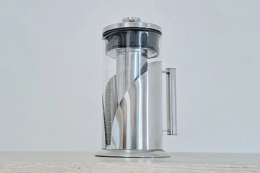  A glass and stainless steel cold brew coffee maker standing on a countertop.