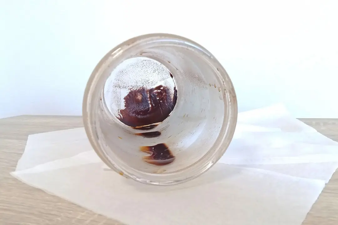 The inside of a cold brew coffee carafe with remaining sediment after the brew has been carefully decanted off.