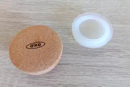 The cork stopper of the Oxo compact cold brew coffee carafe with its silicone seal removed and resting to the right.