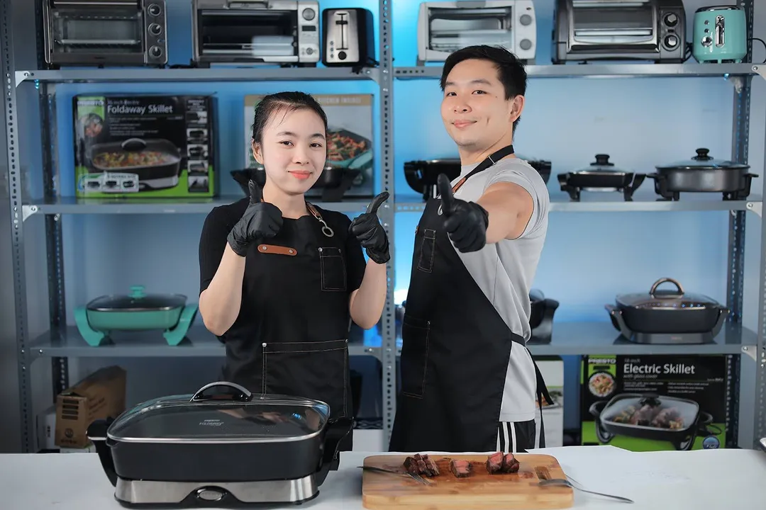 Two people giving thumbs up, the Presto Foldaway Non-Stick Electric Skillet 06857, and slices of steak on a wooden cutting board.