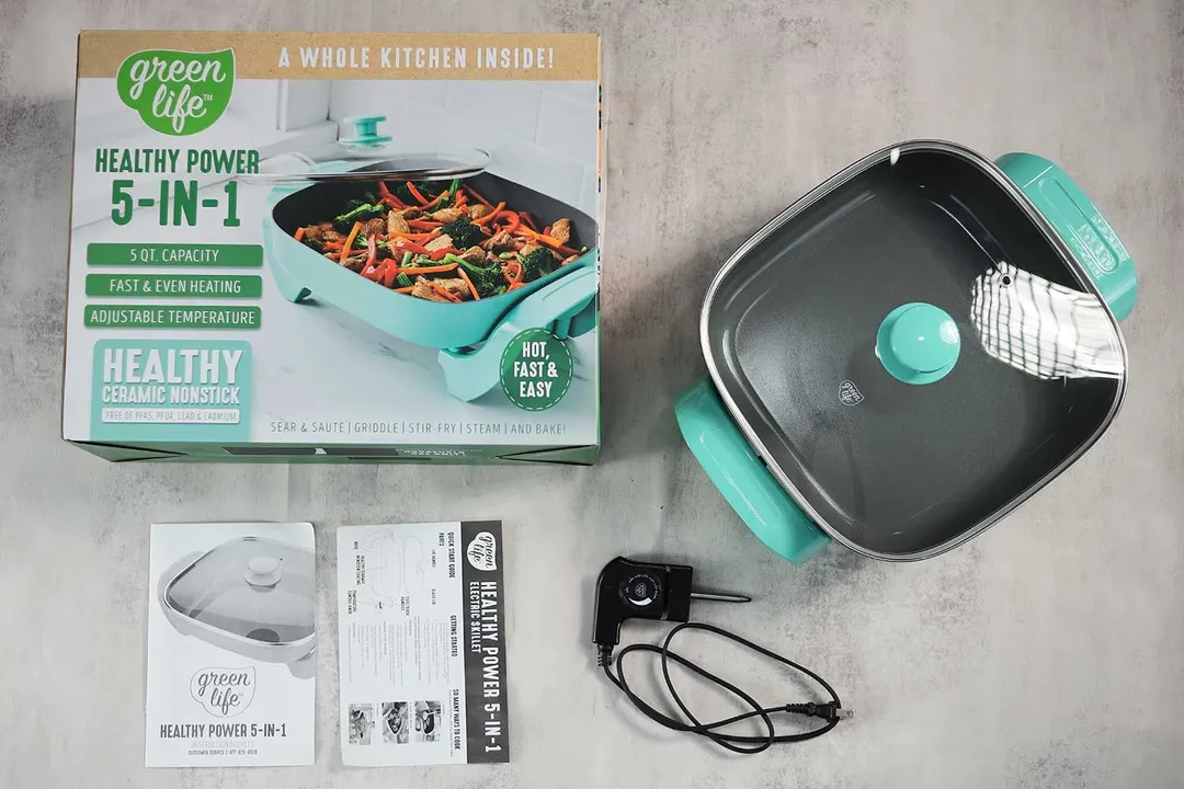 On the upper right is the GreenLife Ceramic Non-Stick Electric Skillet CC003725-002. On the left is its cardboard box. Below the skillet, on the right is a thermostat and on the left is an instruction manual.