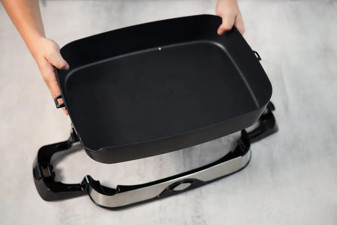 The base of Presto Foldaway Non-Stick Electric Skillet 06857 clips off and the pan can be lifted up.