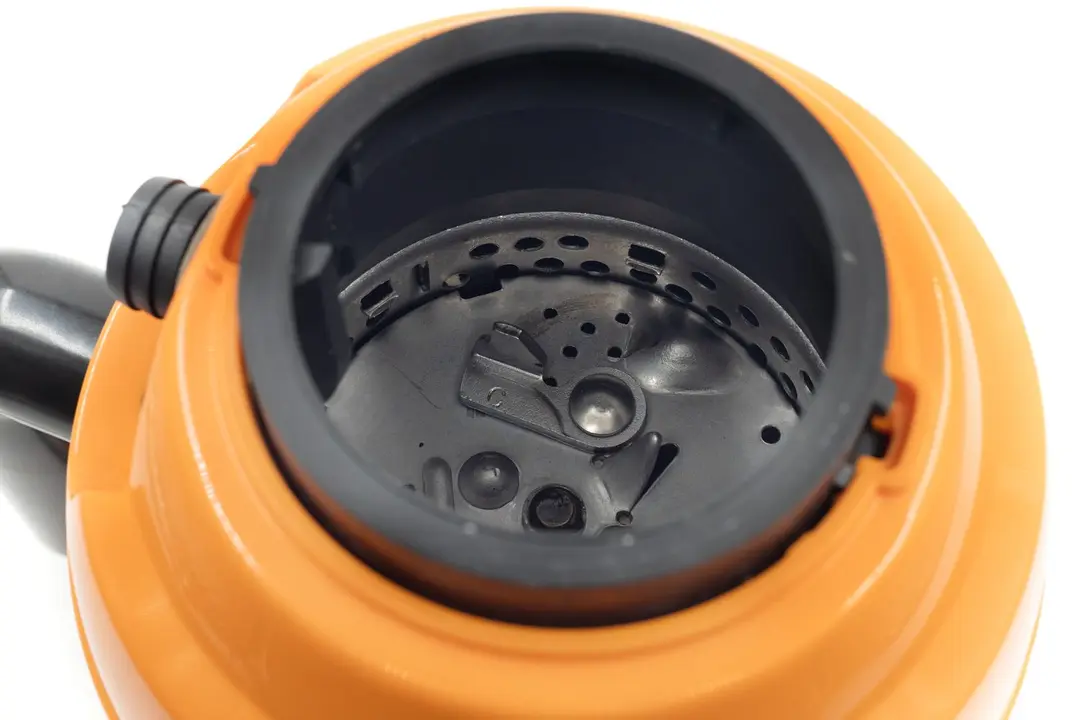 Top view into chamber of AmazonCommercial B07XFDMPNJ garbage disposal after testing, showing layout of grinding components.