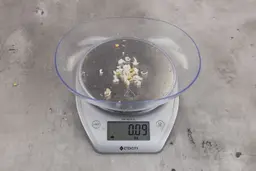 0.09 ounces of shredded fish bone on digital scale.