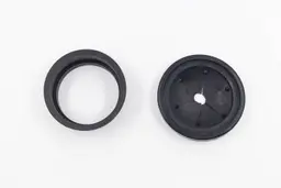Parts of Universal 3-Bolt Mount Adapter kit for garbage disposals displayed on white top, including collar adapter and rubber sink baffle. 