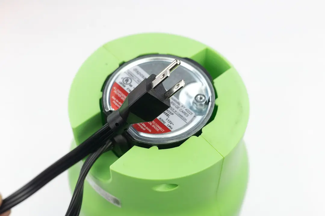 Bottom view of GE Disposall Green 1/2 HP corded garbage disposal with type-B power cord.