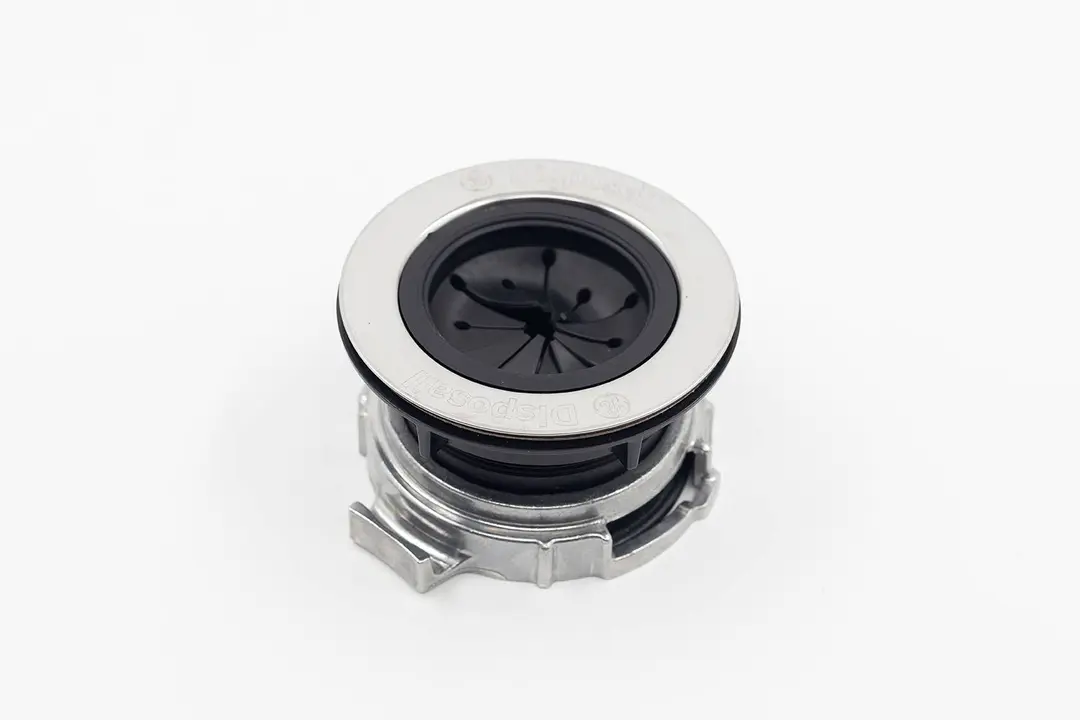 EZ Mount assembly for garbage disposals with splash guard on white platform, GE logo and “Disposall” engravings on rim.