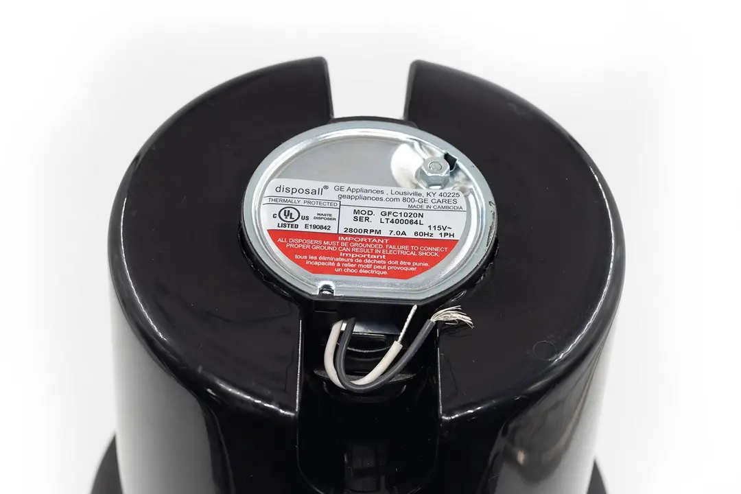 Bottom view of GE GFC1020N non-corded garbage disposal, pre-cut electrical wires, and specification sticker.