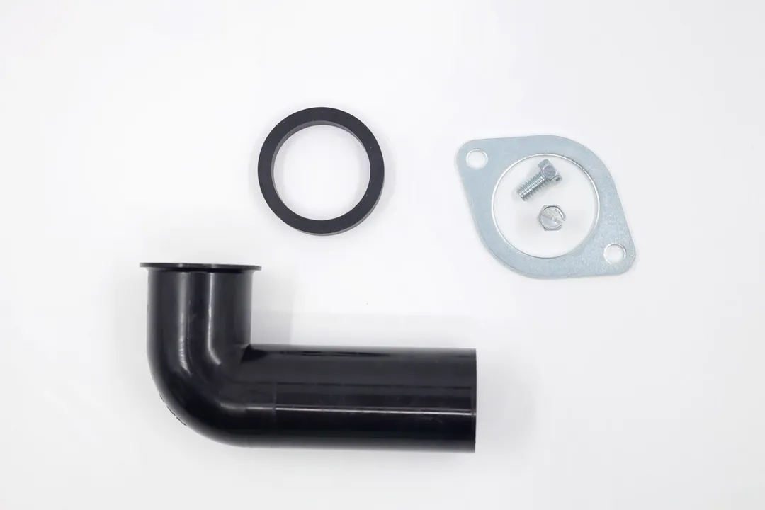Standard outlet/discharge set for garbage disposals on white top, showing elbow pipe, rubber gasket, flange, and bolts.