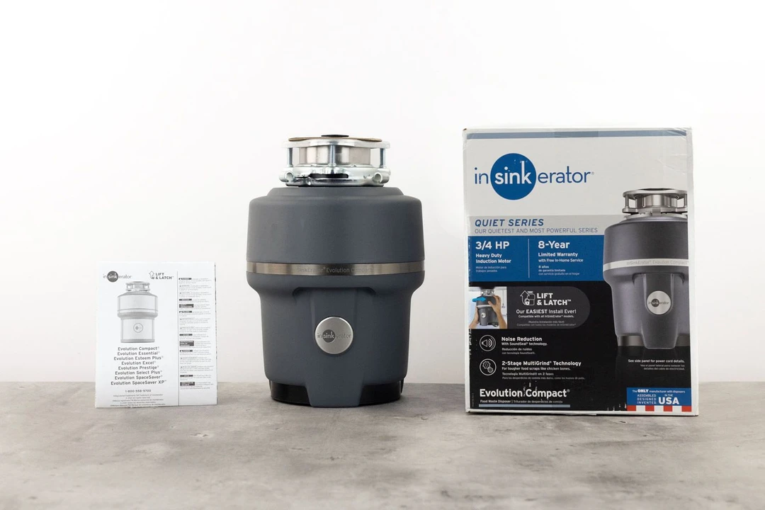 InSinkErator Evolution Compact 3/4-Horsepower Garbage Disposal with 3-Bolt Mount assembly on top, its box, and user manual.