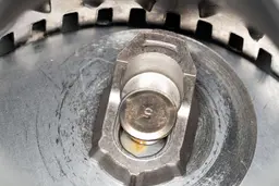 Inside view of InSinkErator Evolution Compact 3/4-hp garbage disposal after testing, highlighting design of impellers, partially showing details of flywheel and grater/grinder ring.