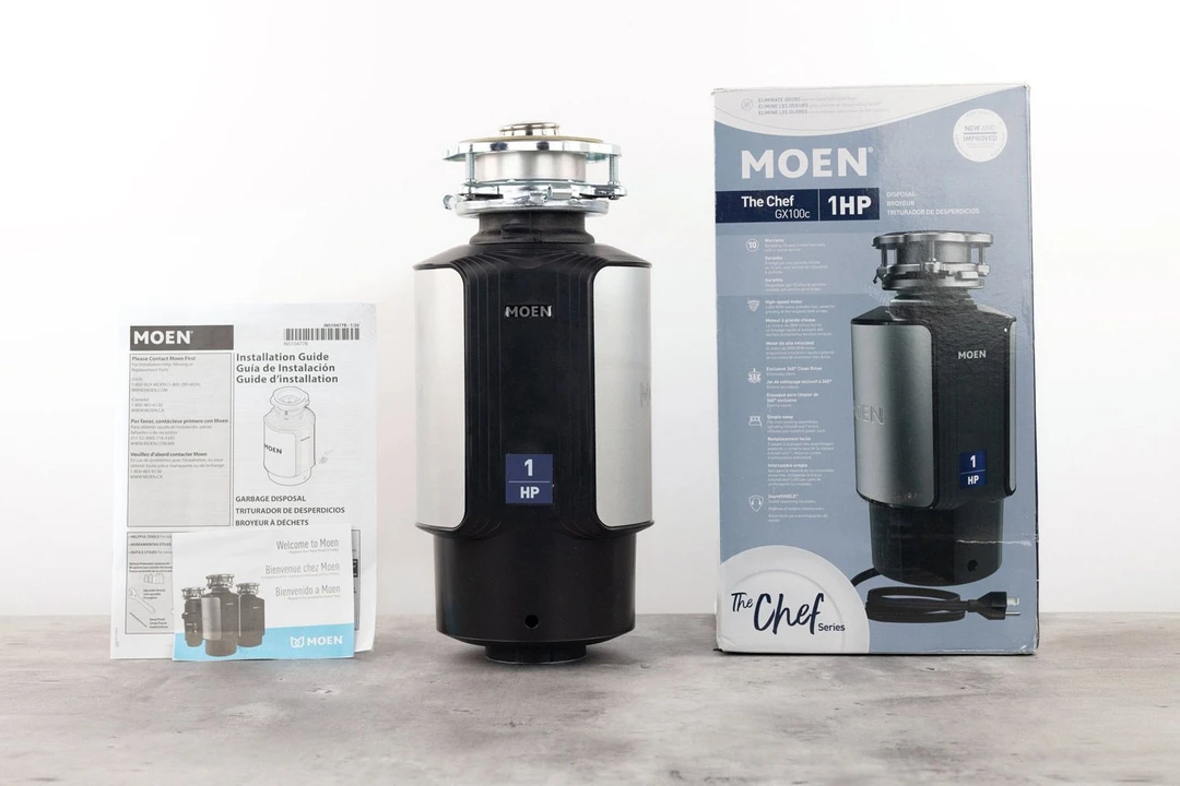 Moen Chef Series GX100C 1 HP Continuous Feed Garbage Disposal, 3-Bolt Mount assembly on top, its box, and user manual.