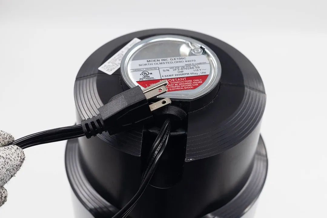 Bottom view of Moen Chef Series GX100C 1 HP corded garbage disposal with type-B power cord.