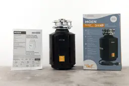 Moen Host Series GXS75C 3/4 HP Continuous Feed Garbage Disposal, 3-Bolt Mount assembly on top, its box, and user manual.