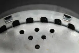 Inside view of Moen Host Series GXS75C garbage disposal, showing design of grater ring and details on flywheel.