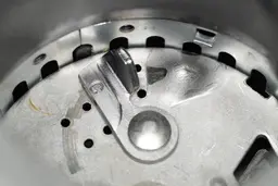 Inside view of Moen Host Series GXS75C food disposer, showing design of impellers and details of flywheel and grater ring.