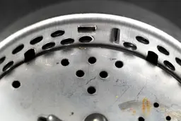 Inside view of Waste King L-8000 garbage disposal, showing design of two-level grater/grinder ring and details on flywheel.