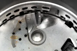Inside view of Waste King L-8000 food disposer, showing design of impellers and details of flywheel and grater/grinder ring.