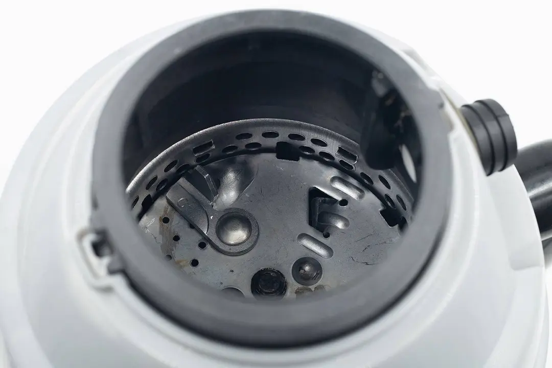 Top view into chamber of Waste King L-8000 garbage disposal after testing, looking at layout of grinding components.