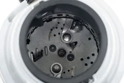 Top view into chamber of Waste King L3200 garbage disposal after testing, showing layout of grinding components.