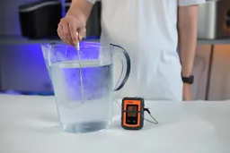 A temperature probe inserted into a jug of water showing a reading of 12℃.