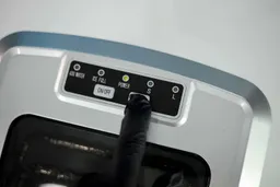 Alt: The Select button being pressed on a countertop ice maker to choose the ice size.