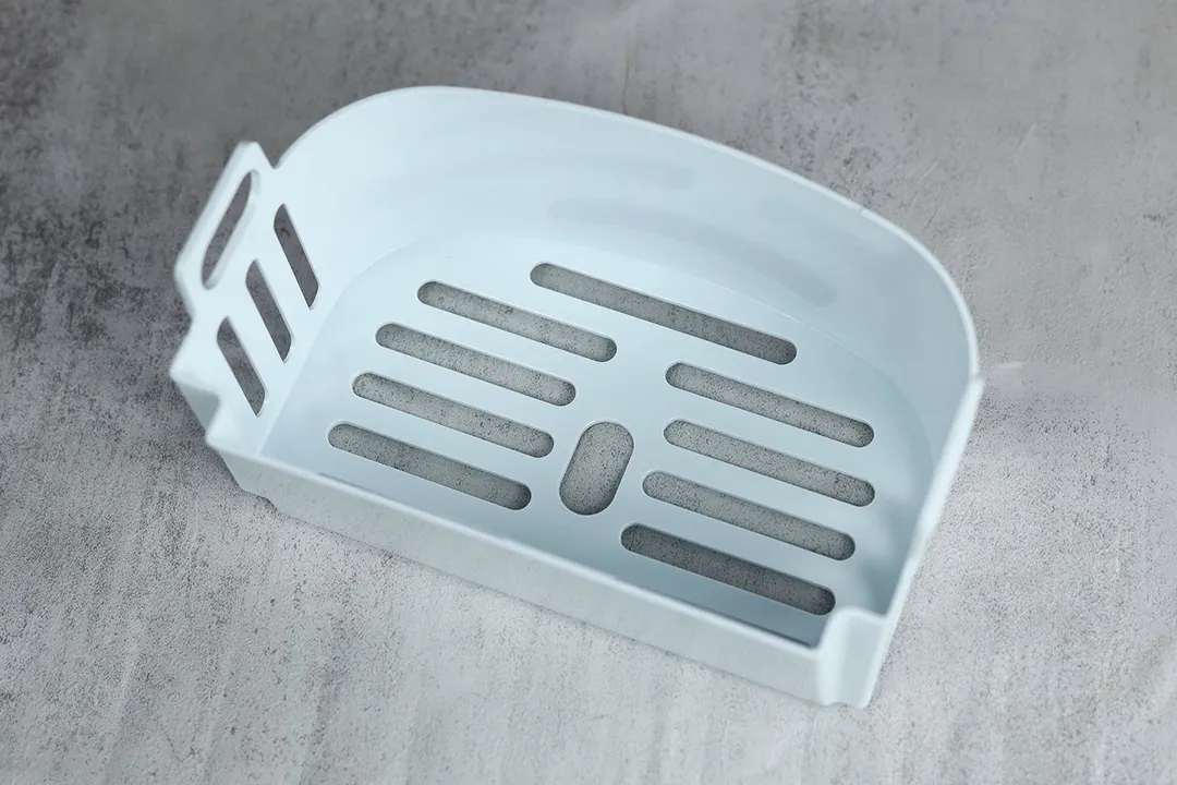 White hard plastic basket of the Frigidaire EFIC189 countertop portable bullet ice maker.