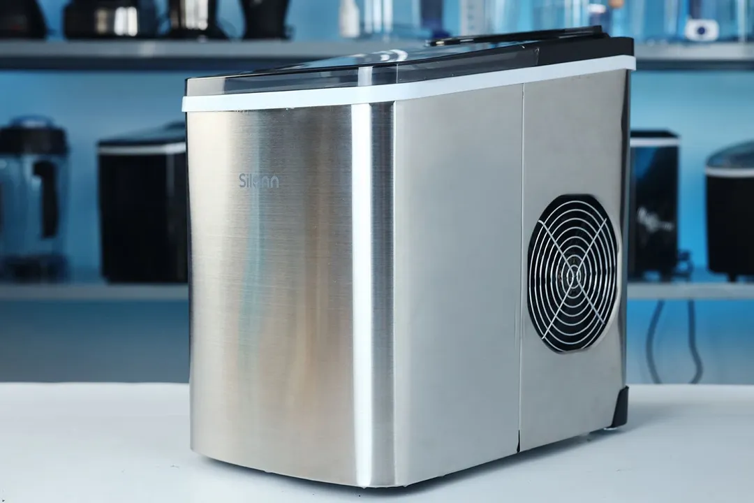 A side view of the Silonn portable ice maker showing the stainless steel body and the extraction fan on the right hand side
