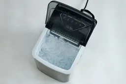 Top down view of the Silonn portable ice maker with its lid open and the basket filled with ice.
